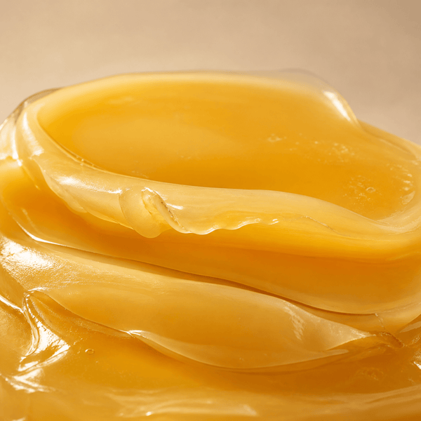 Smooth beeswax texture representing a light protective layer that helps lock in moisture and support skin comfort