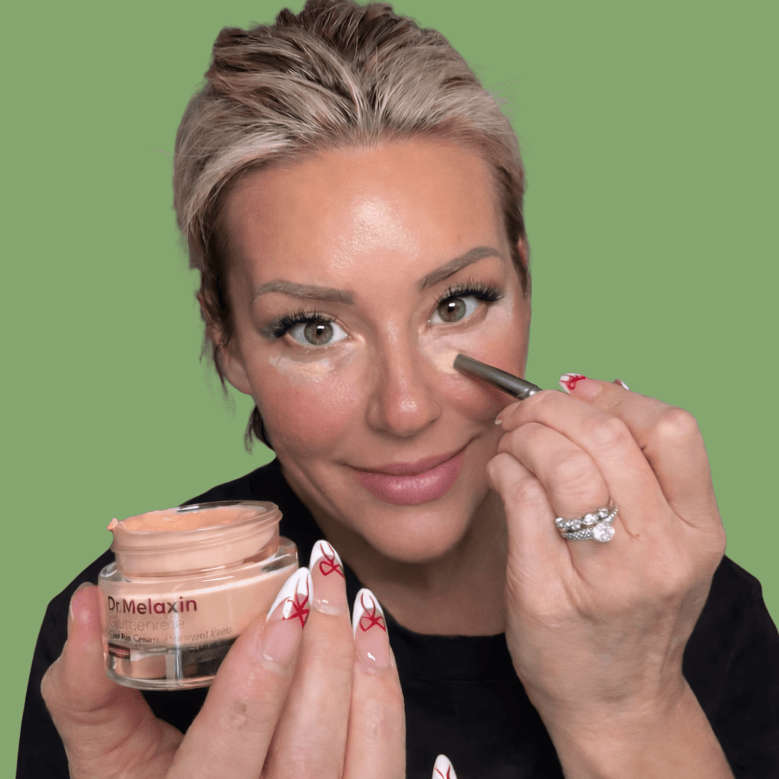 Applying Olivine Beauty Calcium Dark Spot Eye Cream under the eyes with brush applicator