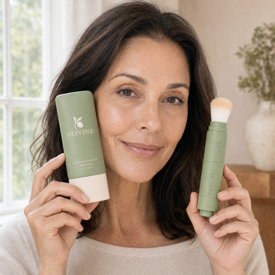 Woman holding Color Correcting Serum and the Soft Set powder brush