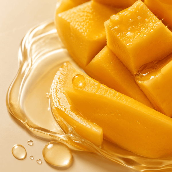 Fresh mango extract skincare ingredient with glossy texture and warm tones by Olivine Beauty