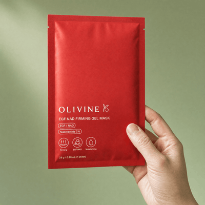 Hand holding the Olivine Beauty EGF NAD Firming Gel Mask sachet