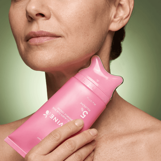 Woman gliding the Olivine Beauty PDRN Collagen Gua Sha Neck Wrinkle Cream applicator along her neck