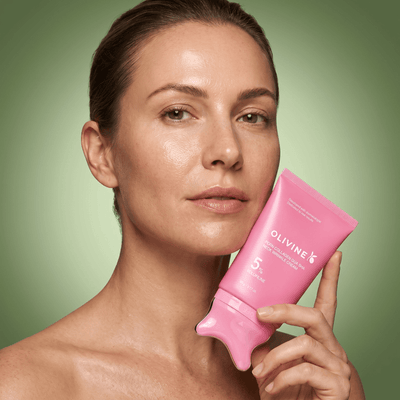 Woman holding the Olivine Beauty PDRN Collagen Gua Sha Neck Wrinkle Cream