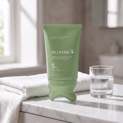 Green Olivine Beauty PDRN Collagen Gua Sha Neck Wrinkle Cream on a marble bathroom vanity