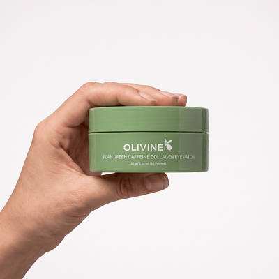 Hand holding the Olivine Beauty PDRN Green Caffeine Collagen Eye Patch jar to show its size