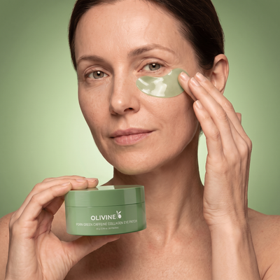 Woman applying an Olivine Beauty PDRN Green Caffeine Collagen Eye Patch under her eye