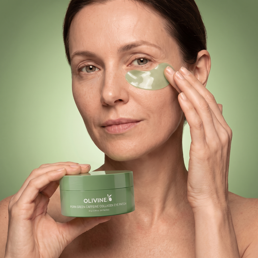 Woman applying an Olivine Beauty PDRN Green Caffeine Collagen Eye Patch under her eye