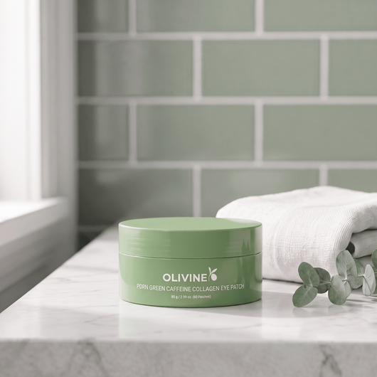 Olivine Beauty PDRN Green Caffeine Collagen Eye Patch jar on a marble bathroom shelf