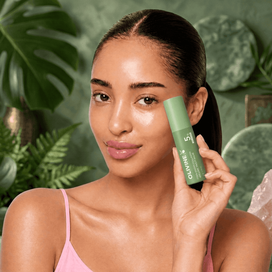 Model applying the Olivine Beauty PDRN Green Collagen Volume Multi Balm stick to her cheek