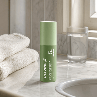 Olivine Beauty PDRN Green Collagen Volume Multi Balm stick on a marble bathroom vanity