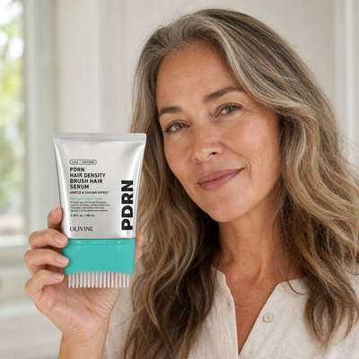 Woman holding the PDRN Hair Density Brush Serum, hair looking fuller