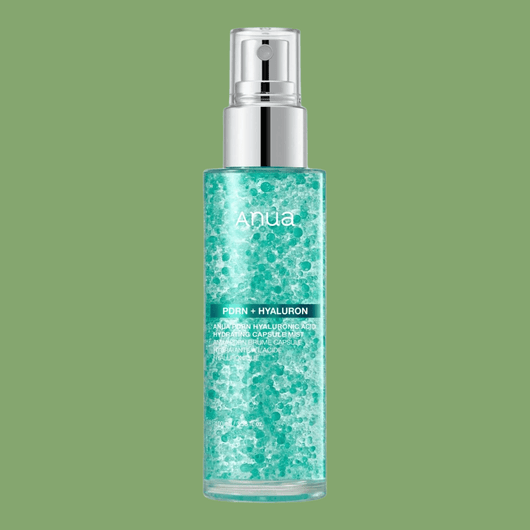 Transparent aqua skincare mist bottle with suspended hydration capsules and silver spray cap.
