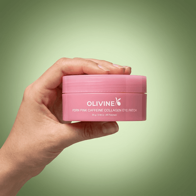 Hand holding the Olivine Beauty PDRN Pink Caffeine Collagen Eye Patch jar to show its size