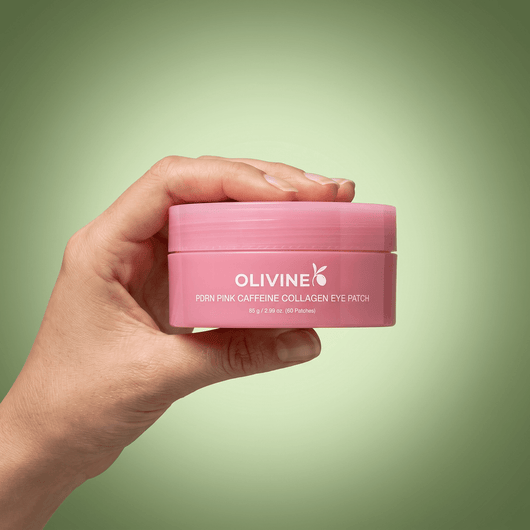 Hand holding the Olivine Beauty PDRN Pink Caffeine Collagen Eye Patch jar to show its size