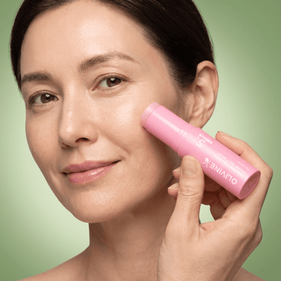 Woman applying the Olivine Beauty PDRN Pink Collagen Volume Multi Balm stick to her cheek