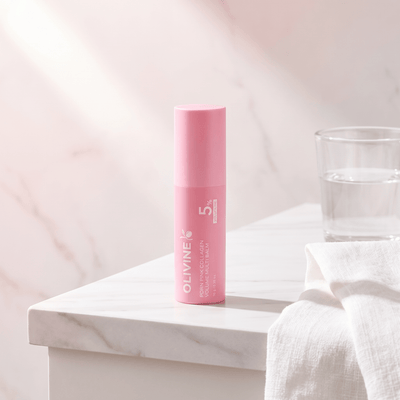 Olivine Beauty PDRN Pink Collagen Volume Multi Balm stick on a marble bathroom vanity