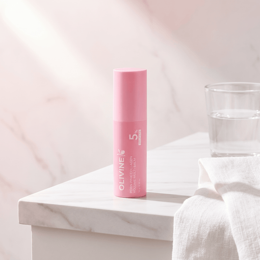 Olivine Beauty PDRN Pink Collagen Volume Multi Balm stick on a marble bathroom vanity