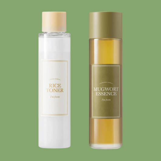 Rice toner and mugwort essence bottles on soft green background