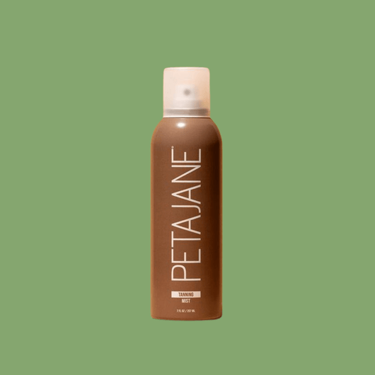 A single bottle of Olivine Beauty Tanning Mist centered on a solid sage green background, highlighting the minimalist packaging.