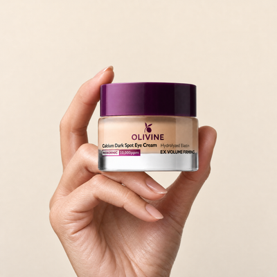 Olivine Calcium Dark Spot Eye Cream held in hand, close up