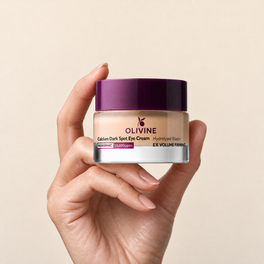 Olivine Calcium Dark Spot Eye Cream held in hand, close up