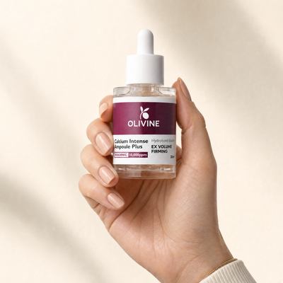 Olivine Calcium Intense Ampoule Plus held in hand, close up