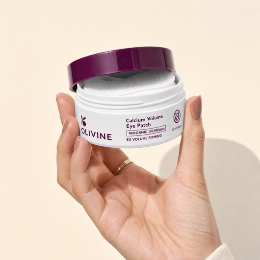 Olivine Calcium Volume Eye Patch held in hand, close up