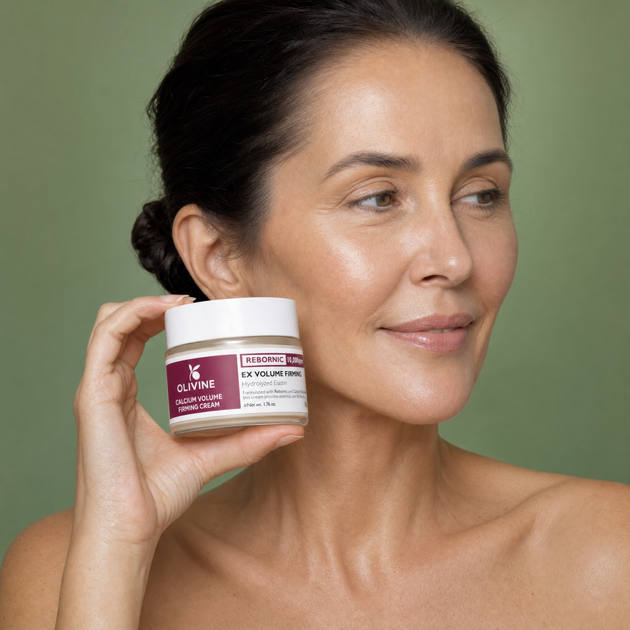 Olivine Calcium Volume Firming Cream applied to the cheek by a woman with glowing skin