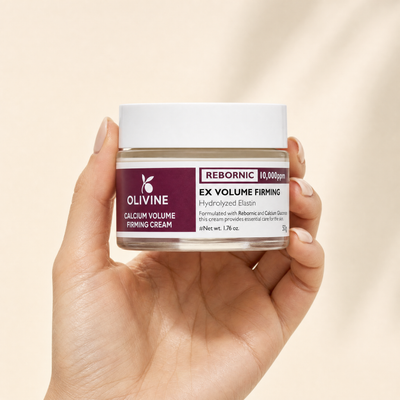 Olivine Calcium Volume Firming Cream held in hand, close up