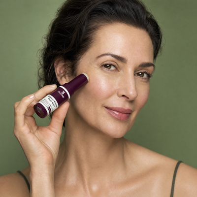 Olivine Calcium Volume Multi Balm applied by a woman with glowing skin