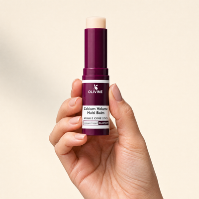 Olivine Calcium Volume Multi Balm held in hand, close up