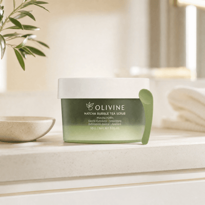 Olivine Matcha PDRN Bubble Tea Scrub in a bright bathroom vanity setting