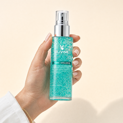Olivine PDRN Collagen Glow Facial Serum Spray held in hand, close up