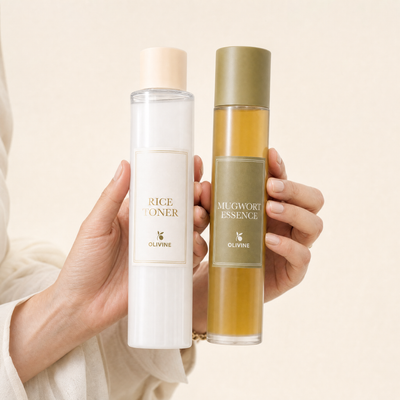 Olivine Skin Flooding Duo Rice Toner and Mugwort Essence held in hand, close up