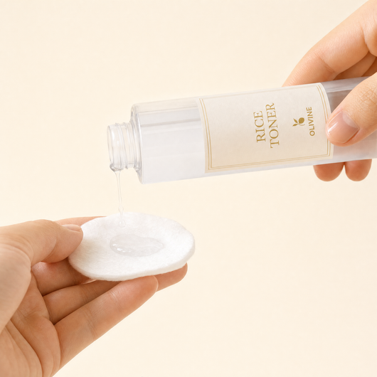 Olivine Skin Flooding Duo Rice Toner poured onto a cotton pad, close up